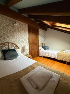 a bedroom with two beds in a room at Chalet turístico La Jenduda in Ojedo +23 photos