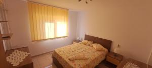 a small bedroom with a bed and a window at Apartament Alina Et 1 in Mangalia