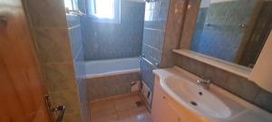 a bathroom with a shower and a tub and a sink at Apartament Alina Et 1 in Mangalia