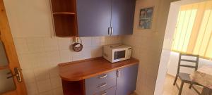 a small kitchen with a microwave on a counter at Apartament Alina Et 1 in Mangalia +12 photos