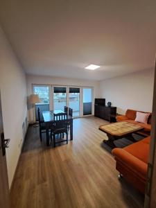 a living room with a couch and a table at Apartment Hermeskeil in Hermeskeil