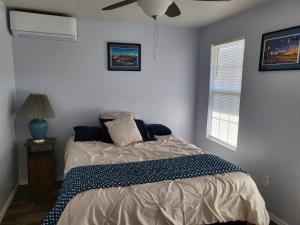 a bedroom with a bed and a ceiling fan at Dream Catcher in Truth or Consequences