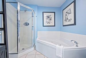 a bathroom with a shower and a bath tub at Lighthouse 1610 in Gulf Shores +18 photos
