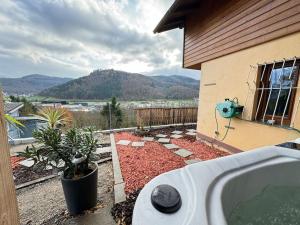 a backyard with a bath tub in front of a house at Alsace Mountain House in Munster +5 photos