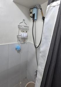 a shower in a bathroom with a hose hooked up at JTropics Plumera Mactan Near Airports, Malls and Beaches in Lapu Lapu City