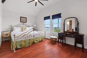 a bedroom with a bed and a dresser and a mirror at Sunrise in Paradise-BeachFront-Fenced Yard-Pets-Sleeps 11 in Galveston +47 photos