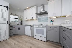 a white kitchen with white cabinets and white appliances at Gulf Side Townhomes 20 condo in Gulf Shores