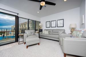 a living room with white furniture and a large window at Gulf Side Townhomes 20 condo in Gulf Shores