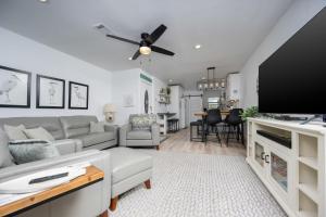 a living room with a couch and a flat screen tv at Gulf Side Townhomes 20 condo in Gulf Shores +27 photos
