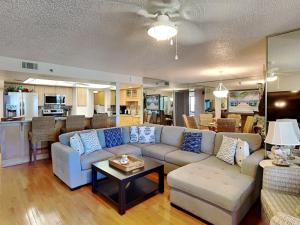 a living room with a couch and a table at Oceanfront Penthouse 11b in Ormond Beach