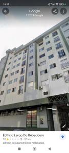 a large white building with windows on the side of it at Apartamento central in Passo Fundo