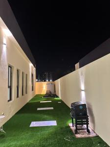 a hallway with green grass in a building at night at Masfout Oasis Hatta استراحة واحة مصفوت حتا in Sharīyah