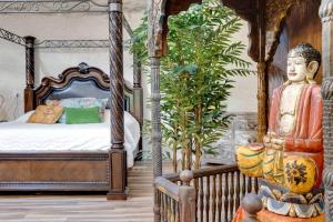 a bedroom with a bed with a statue in it at Adults Only - Secluded Mountainside Dome Retreat in Stanley