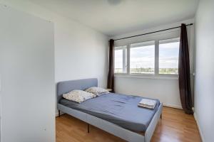 Postel nebo postele na pokoji v ubytování Cocon Ris-Orangis