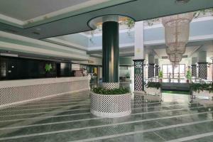 a lobby of a building with a column in it at Club Paraiso in Adeje +32 photos