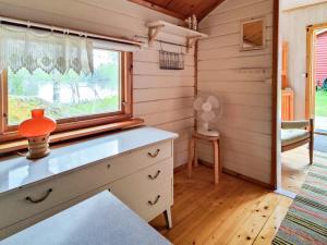 a kitchen with a dresser and a window at 5 person holiday home in KARLSKOGA in Karlskoga