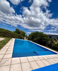 a large swimming pool with blue water at Seven Hotel - Juana Koslay San Luis in Juana Koslay 
