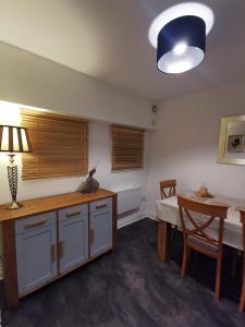 a room with a bed and a table with a lamp at Sun Gardens Retreat- can sleep 10 with 4 Double Beds & 2 sofa beds in Stockton-on-Tees +13 photos