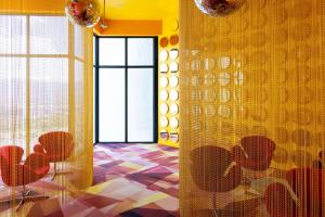 a room with a table and chairs and a window at Jungle at 24, City Views and Wonderland Vibes! in Hatillo