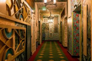 a hallway with colorful tiles on the walls at Jungle at 24, City Views and Wonderland Vibes! in Hatillo
