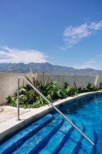 a swimming pool with a view of the mountains at Firefly at 29, City Views and Wonderland Vibes! in Hatillo