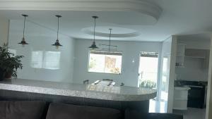 a kitchen with a counter top in a room at Casa de alto padrão perto da praia in Porto Seguro
