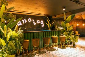 a bar with stools and a sign that saysarma at Sunflower at 12, City Views and Wonderland Vibes! in Hatillo