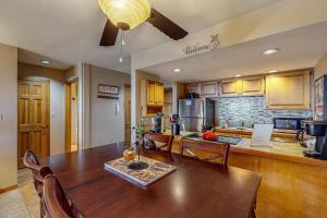 a kitchen with a large wooden table and a dining room at Whispering Pines in Durango Mountain Resort