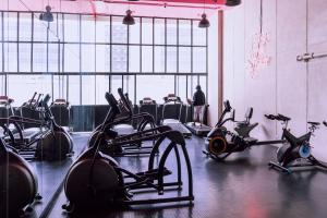 a gym with cardio machines and a man in the background at Teal at 12, City Views and Wonderland Vibes! in Hatillo