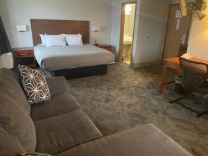 a hotel room with a bed and a couch at Lincoln Hotel in Lincoln