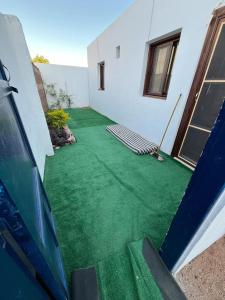 a backyard with a green lawn in front of a house at Holidays home in Dahab +7 photos