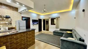 a living room with a couch and a kitchen at Holidays home in Dahab
