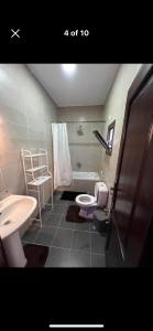 a bathroom with a sink and a toilet and a tub at Holidays home in Dahab