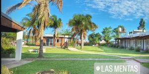 a resort with palm trees and a building at Las Mentas in Victoria
