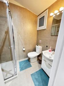 a bathroom with a shower and a toilet and a sink at Smart Deluxe Studio N9 private Kitchenette Balcony Beach 250m Marina Port 900m in Limassol