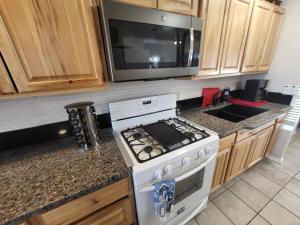 a kitchen with a stove and a microwave at Dream Catcher in Truth or Consequences
