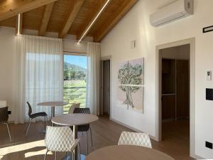 a room with tables and chairs and a window at B&B Agriturismo Lombardi Bologna - San Lazzaro in La Mura