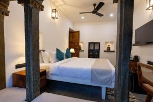 a bedroom with a bed and a ceiling fan at Madri Retreat - Heritage Boutique Hotel with Pool in Udaipur +42 photos