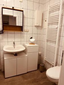 a white bathroom with a sink and a toilet at Apartment 6 Große Brüdergasse in Bautzen