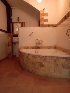 a bath tub in a bathroom with a sink at El callejón del Santo in Ubrique