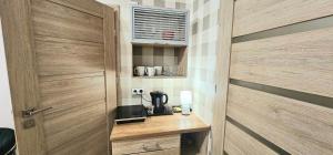 a door leading into a kitchen with a coffee maker at Villa Vita - Apartamenty in Inowrocław +28 photos
