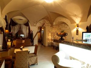 a living room with a table and chairs at Apartments Almandine in Prague
