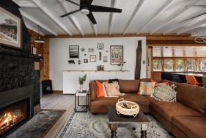 a living room with a couch and a fireplace at Riverfront w Deck Grill Fire pit & Climbing Wall in Hedgesville