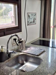 a kitchen counter with a sink and a window at PIRIA in Playa Hermosa