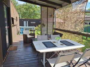 a patio with a white table and chairs on a deck at PIRIA in Playa Hermosa