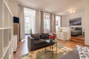 a living room with a couch and a table at großartige Wohnung im Loft-Stil in bester Leipziger Lage in Leipzig