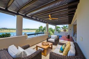 a living room with a couch and a table at PH Condo Lago in El Encanto -Lake View Penthouse with Pool Punta Mita in Punta Mita