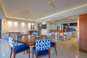 a dining room and kitchen with a table and chairs at PH Condo Lago in El Encanto -Lake View Penthouse with Pool Punta Mita in Punta Mita