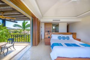 a bedroom with a bed and a balcony at PH Condo Lago in El Encanto -Lake View Penthouse with Pool Punta Mita in Punta Mita +53 photos