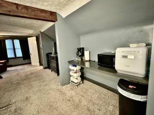 a room with a counter with a microwave on it at Schillhaus Lvl 3 in Louisville
